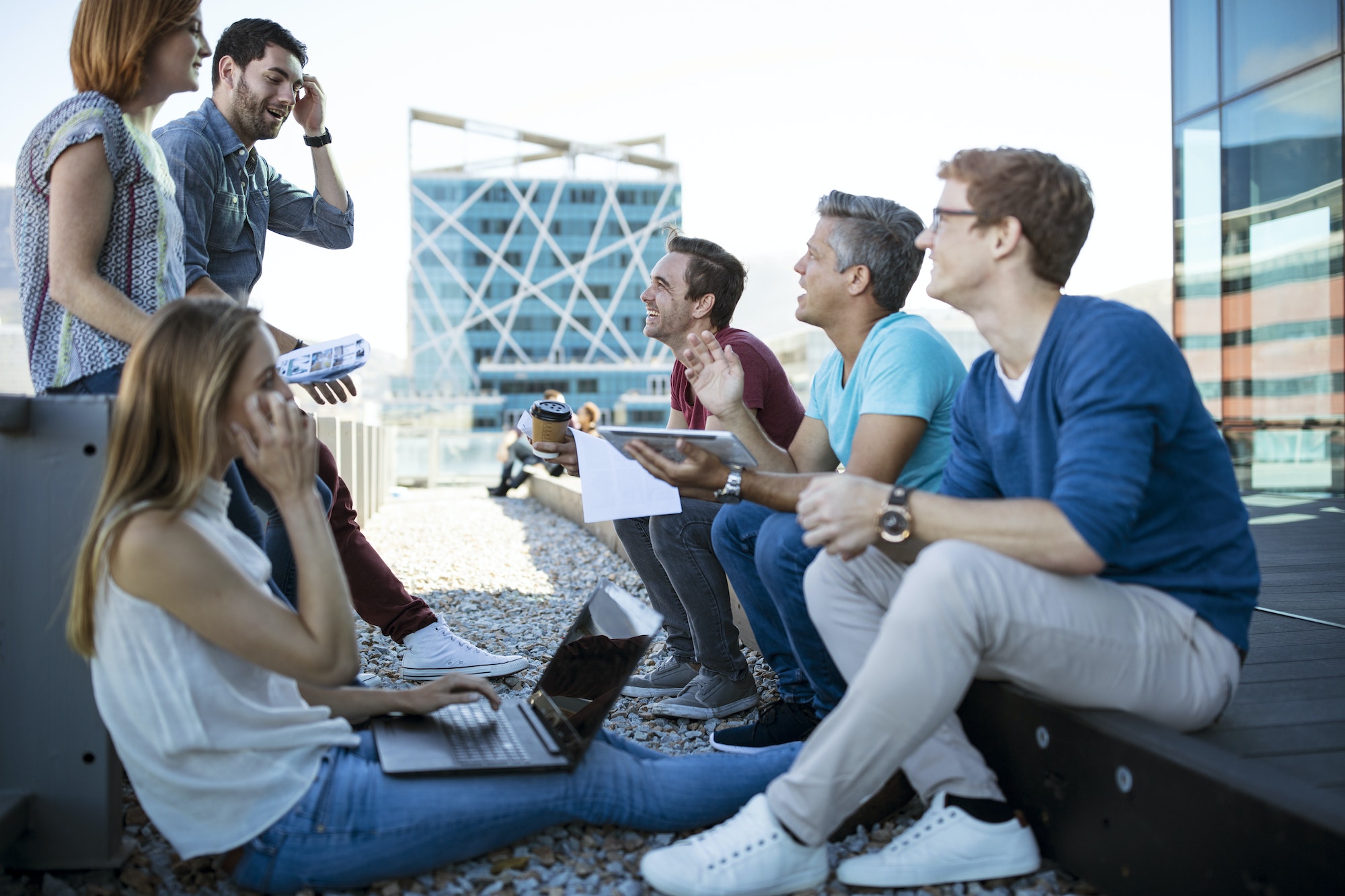 Business people having a casual meeting on a rooftop terrace